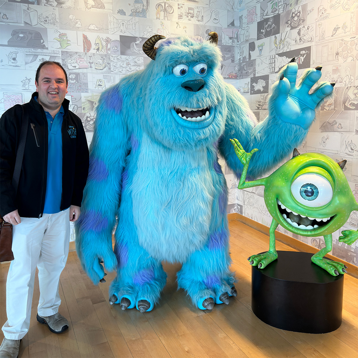 A photo of me Next to Mike and Sulley from Monsters Inc. at the Pixar Campus